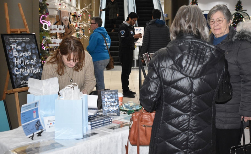 At Sudbury Market, author Trina Brooks signs books for her small town murder mystery
